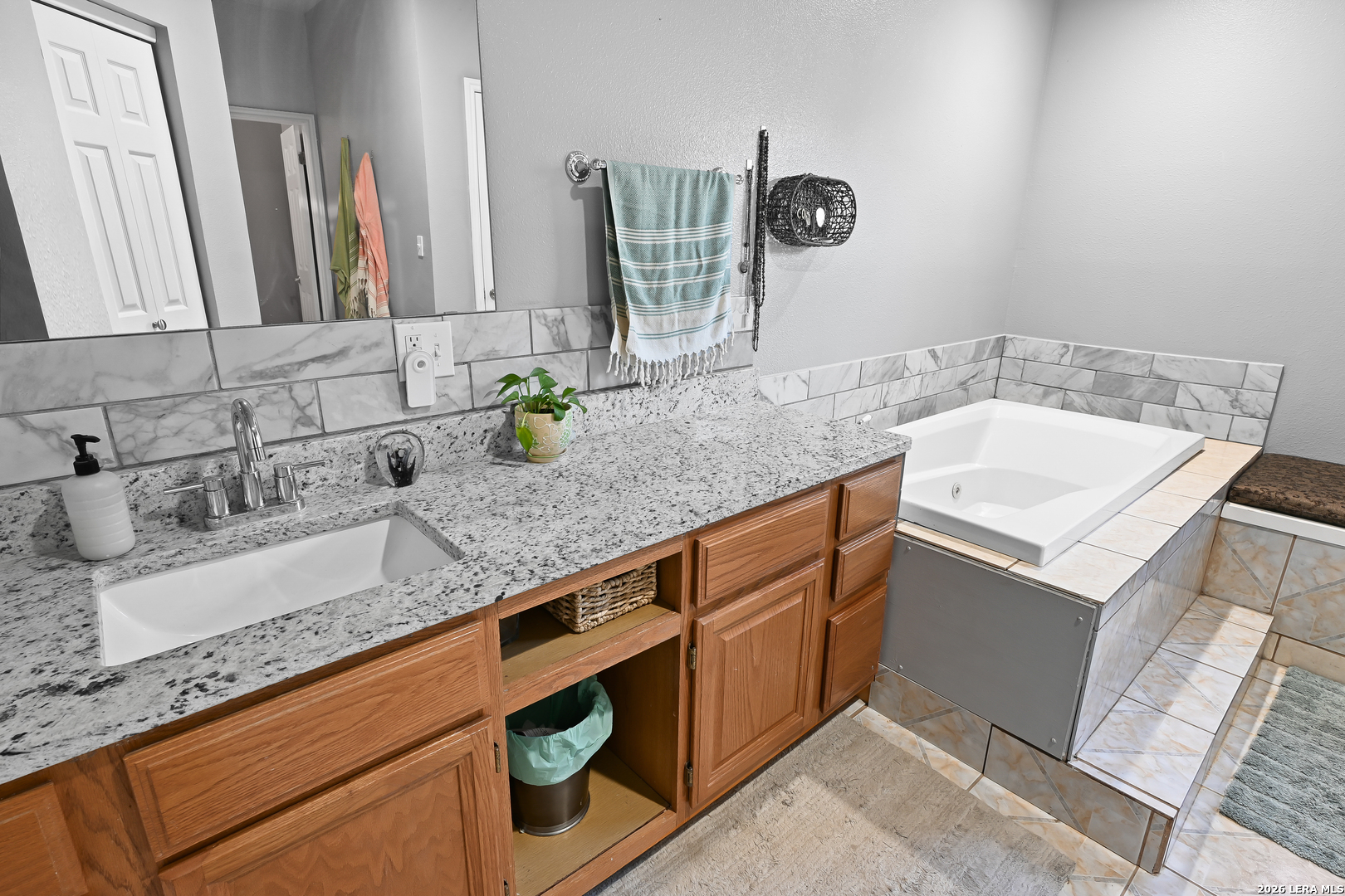 713 Lake Forest Road Pipe Creek, TX 78063 - Photo 16 of 65 a bathroom with a sink and a mirror