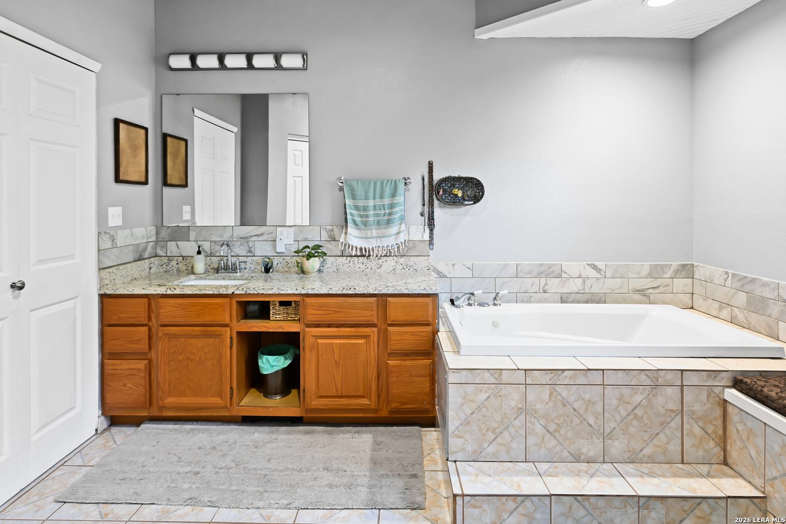 713 Lake Forest Road Pipe Creek, TX 78063 - Photo 17 of 65 a bathroom with a sink a vanity and a mirror