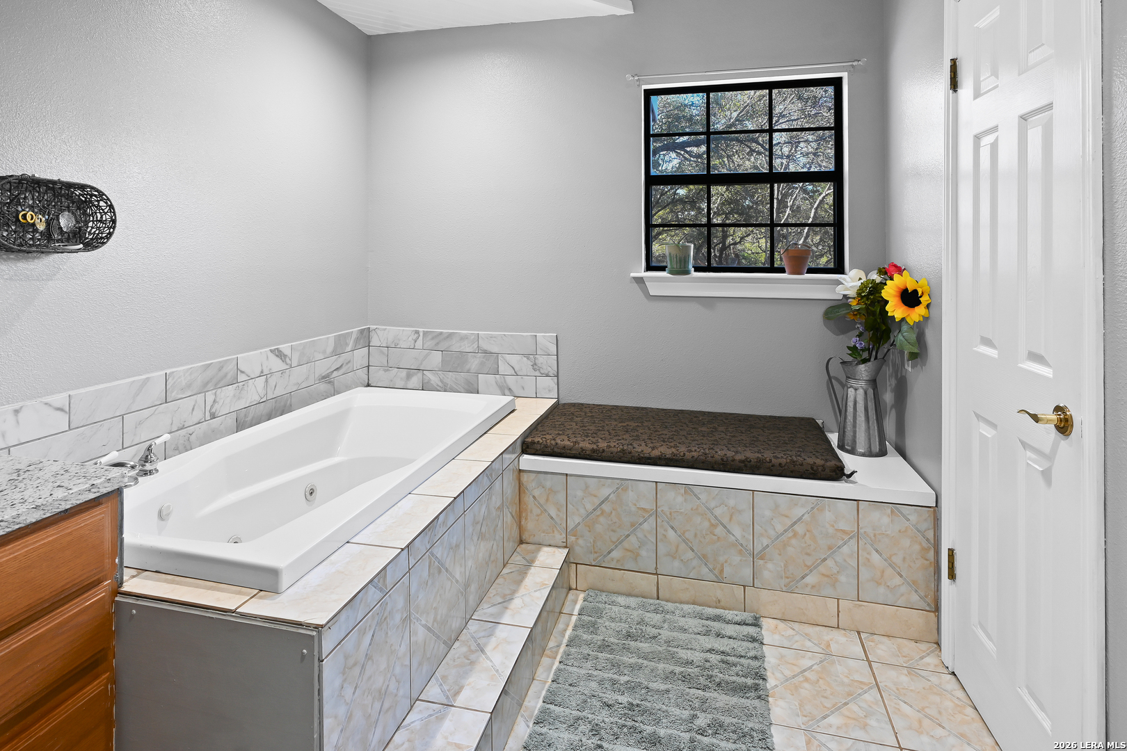 713 Lake Forest Road Pipe Creek, TX 78063 - Photo 18 of 65 a bathroom with a tub sink and mirror