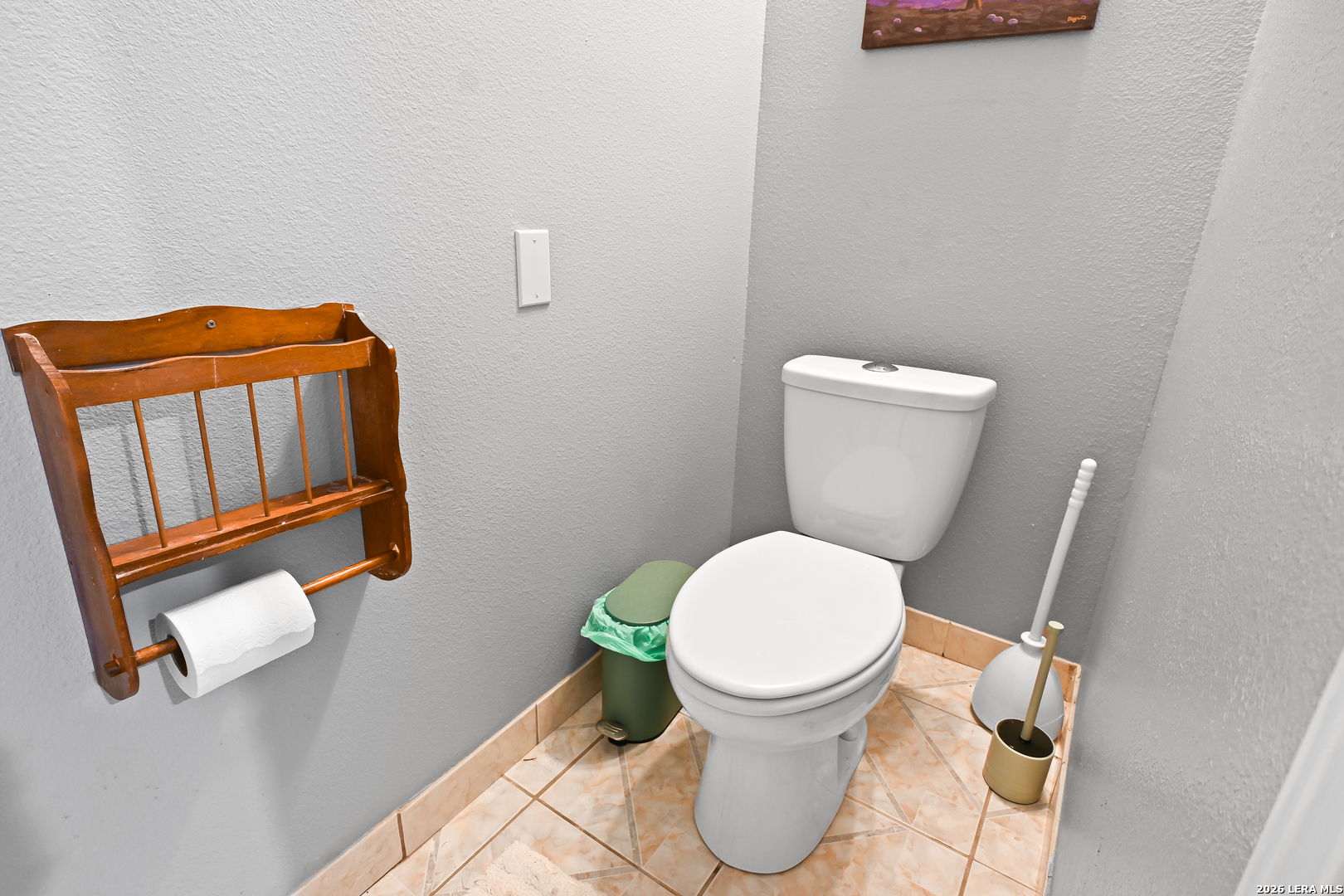 713 Lake Forest Road Pipe Creek, TX 78063 - Photo 19 of 65 a white toilet sitting next to a bathroom sink