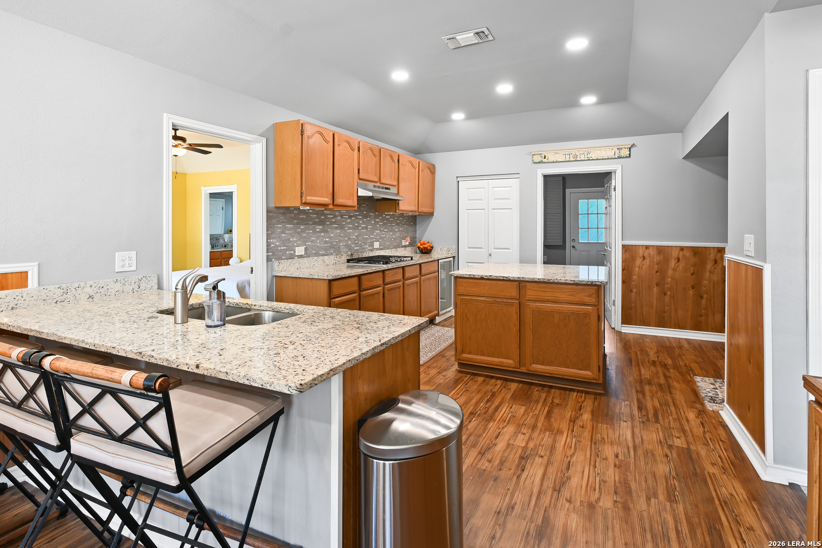713 Lake Forest Road Pipe Creek, TX 78063 - Photo 22 of 65 a large kitchen with a table and chairs in it