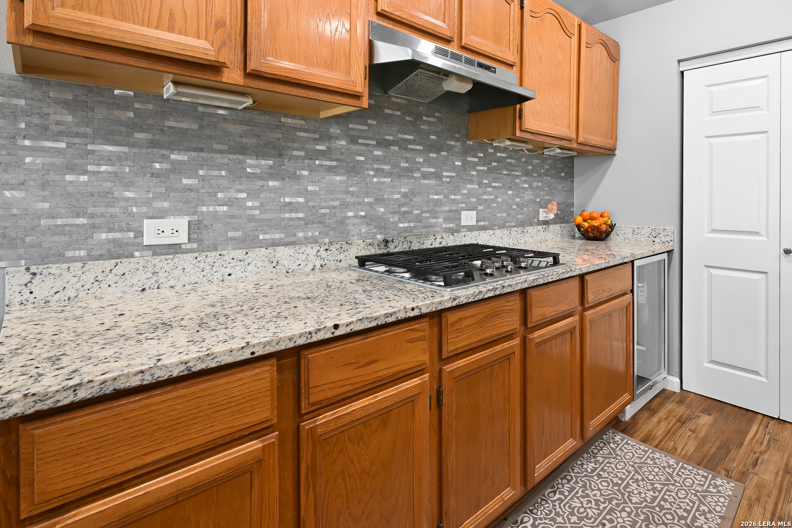 713 Lake Forest Road Pipe Creek, TX 78063 - Photo 23 of 65 a kitchen with granite countertop cabinets and stove
