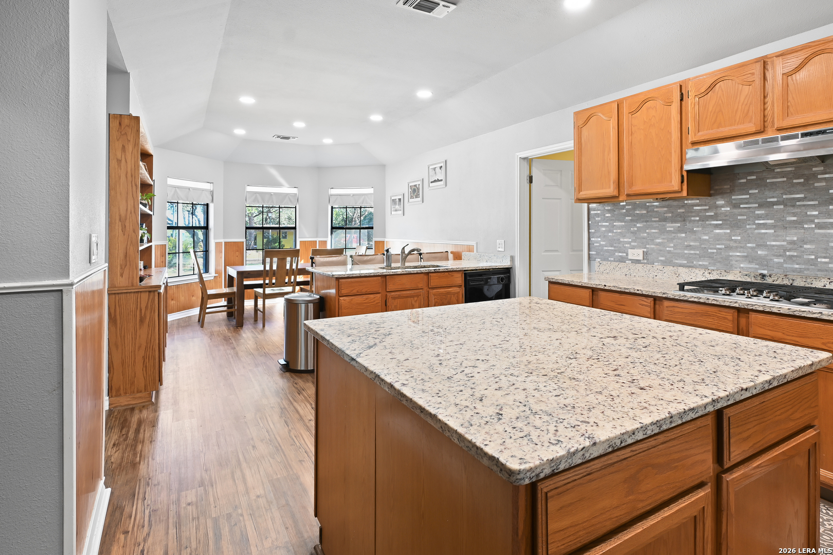 713 Lake Forest Road Pipe Creek, TX 78063 - Photo 25 of 65 a kitchen with stainless steel appliances granite countertop wooden cabinets and granite counter tops