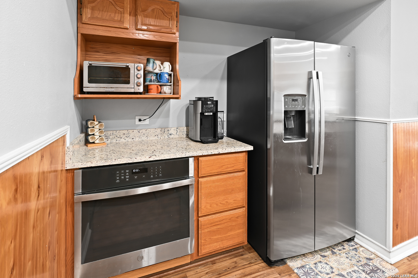 713 Lake Forest Road Pipe Creek, TX 78063 - Photo 26 of 65 a kitchen with stainless steel appliances granite countertop a refrigerator and a stove top oven
