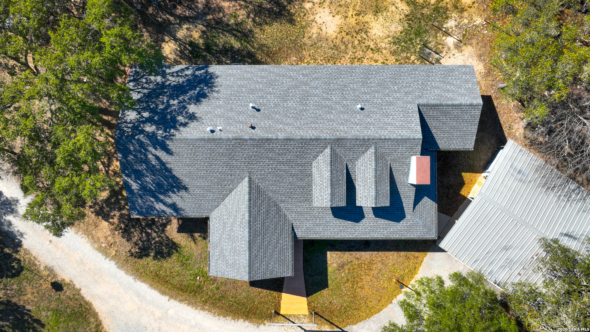713 Lake Forest Road Pipe Creek, TX 78063 - Photo 3 of 65 a front view of a house with garden