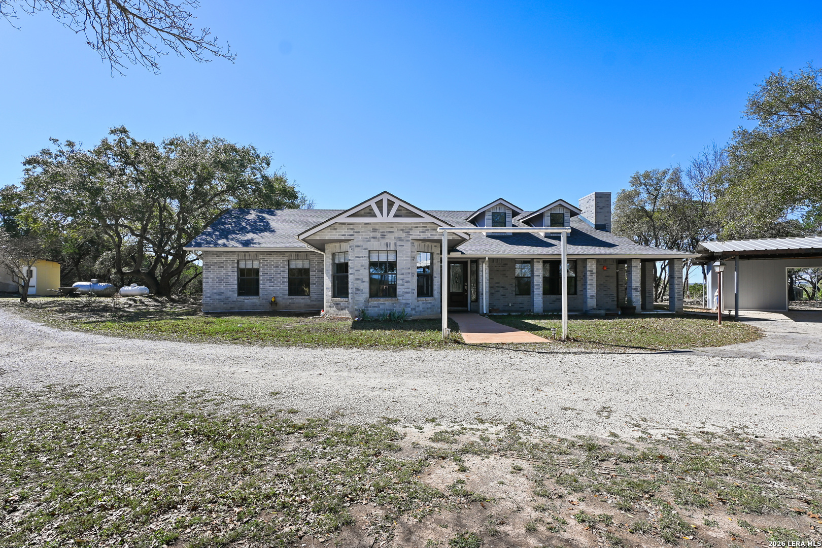 713 Lake Forest Road Pipe Creek, TX 78063 - Photo 31 of 65 a front view of a house with a yard
