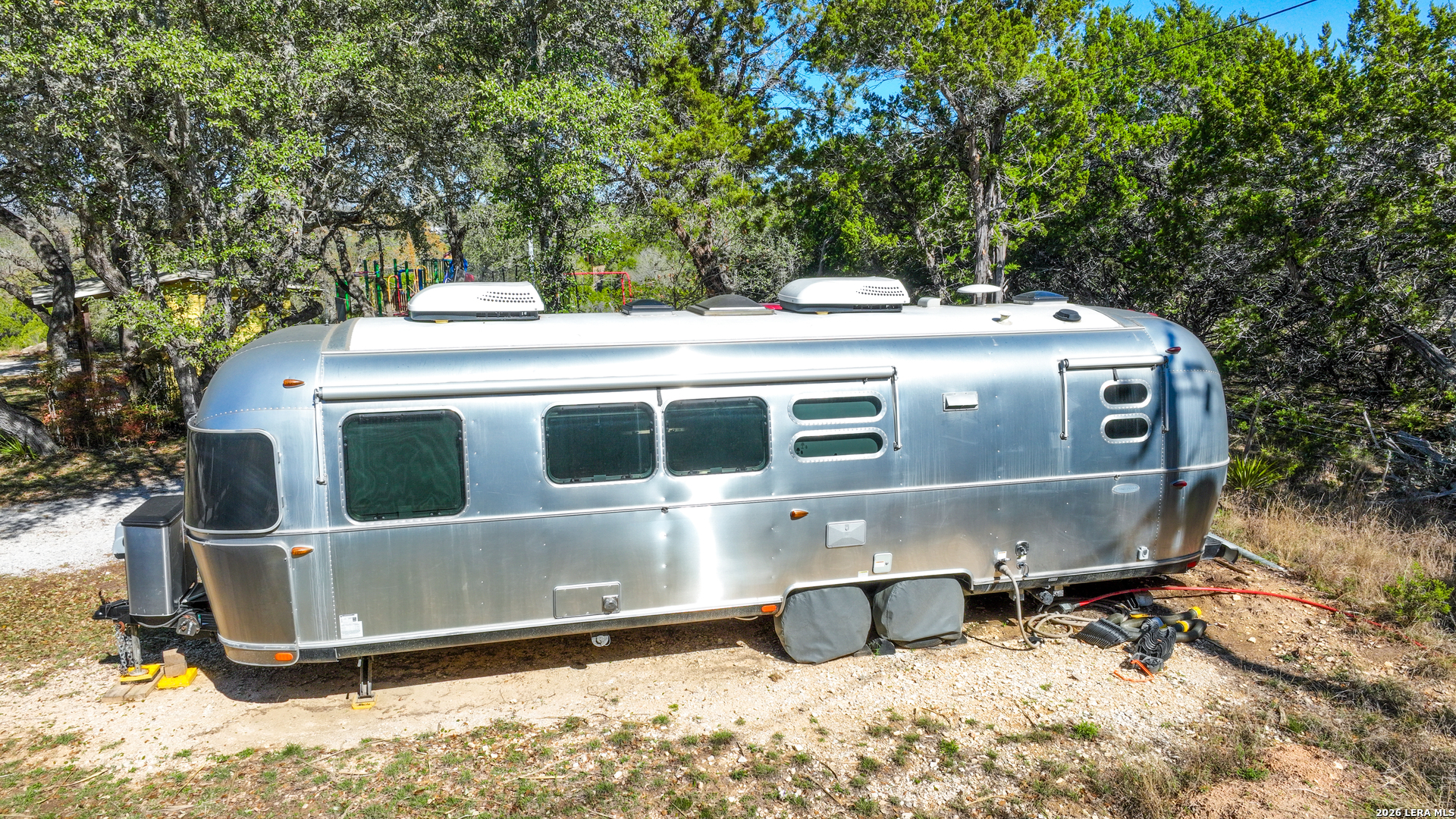 713 Lake Forest Road Pipe Creek, TX 78063 - Photo 37 of 65 a view of a house with a yard