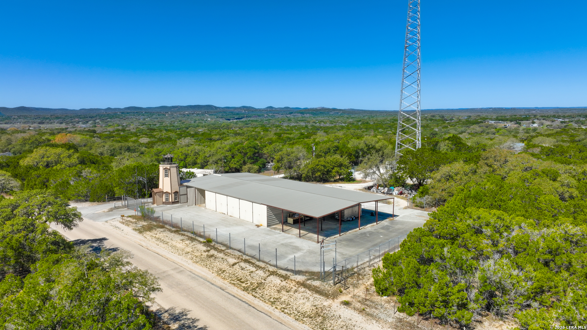 713 Lake Forest Road Pipe Creek, TX 78063 - Photo 48 of 65 a view of a terrace with a garden