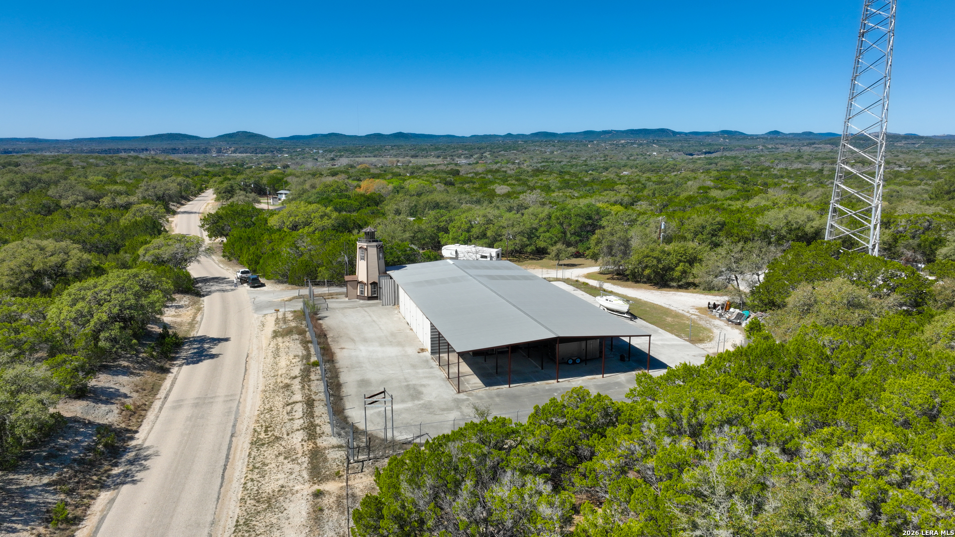 713 Lake Forest Road Pipe Creek, TX 78063 - Photo 51 of 65 a view of a terrace with a garden