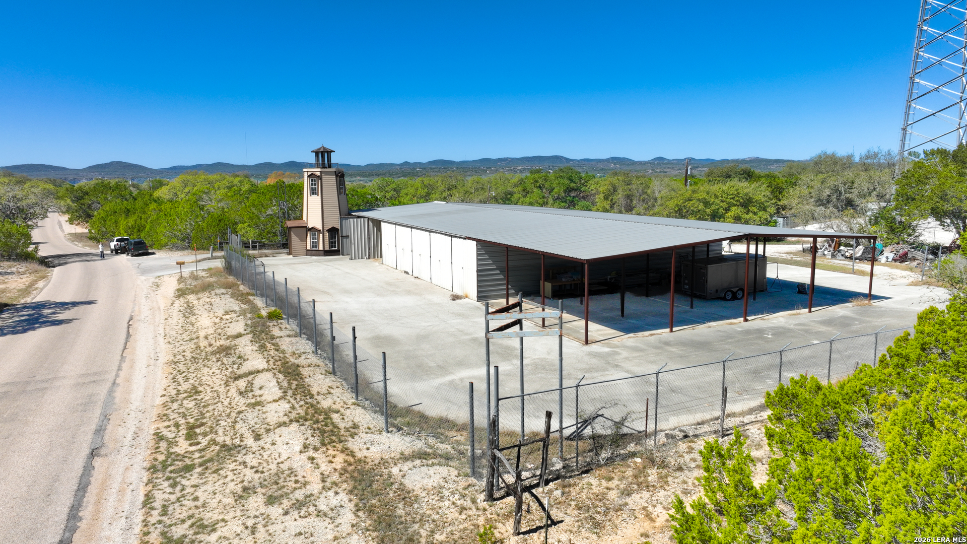713 Lake Forest Road Pipe Creek, TX 78063 - Photo 53 of 65 a view of a terrace with couches and wooden fence
