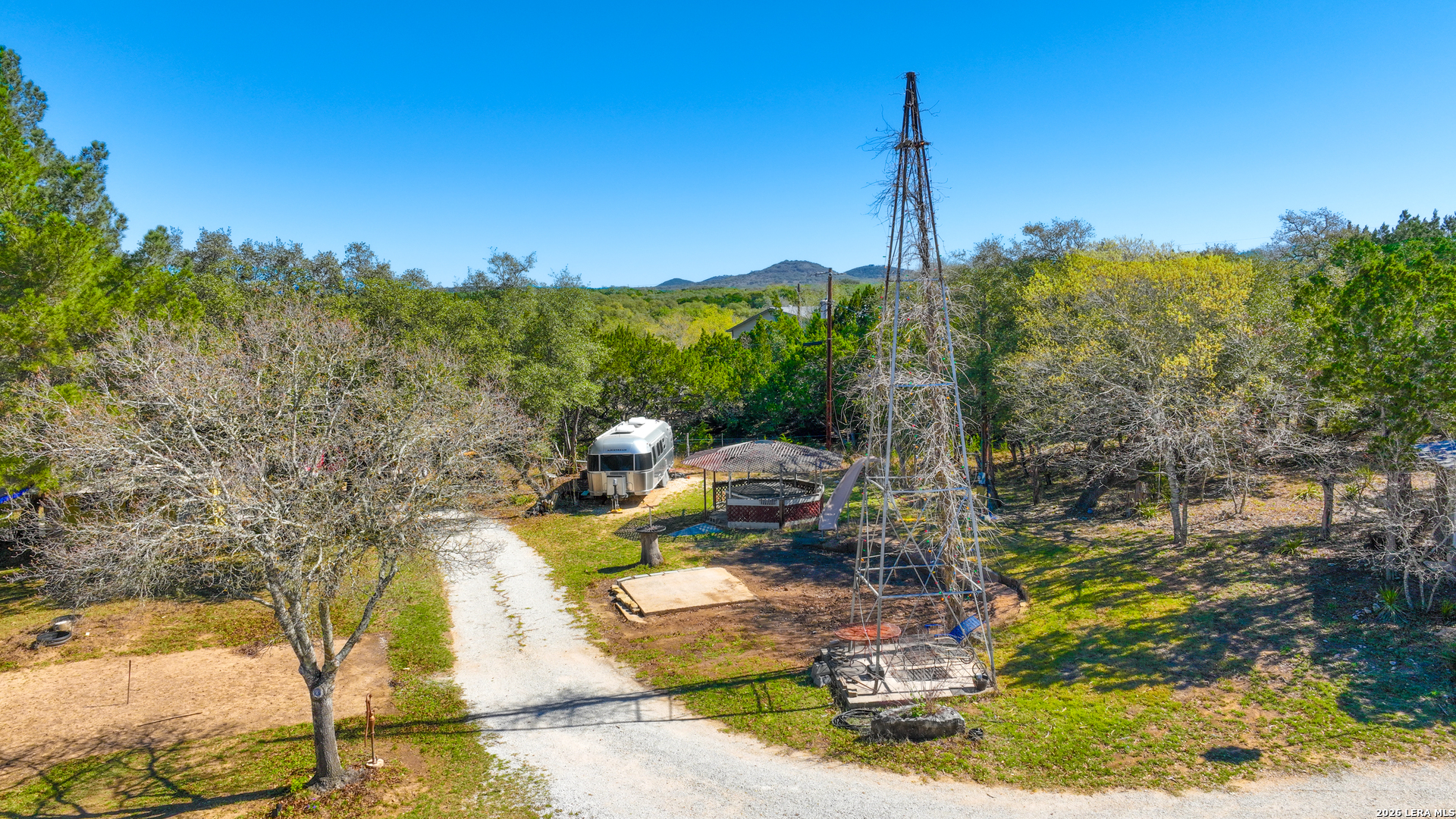 713 Lake Forest Road Pipe Creek, TX 78063 - Photo 6 of 65 a view of a house with a yard