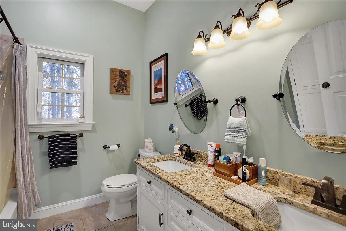 338 Candy Road Mohnton, PA 19540 - Photo 34 of 63 a bathroom with a granite countertop toilet sink and mirror