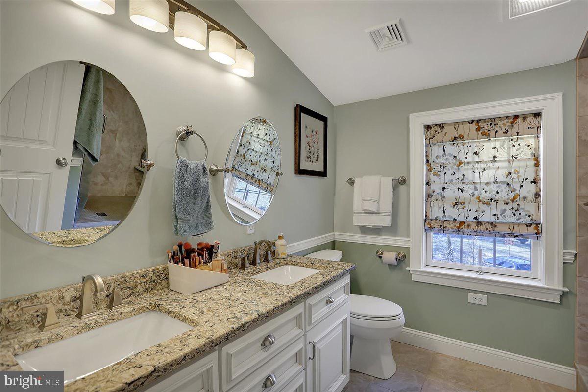 338 Candy Road Mohnton, PA 19540 - Photo 41 of 63 a bathroom with a granite countertop toilet a sink and a mirror