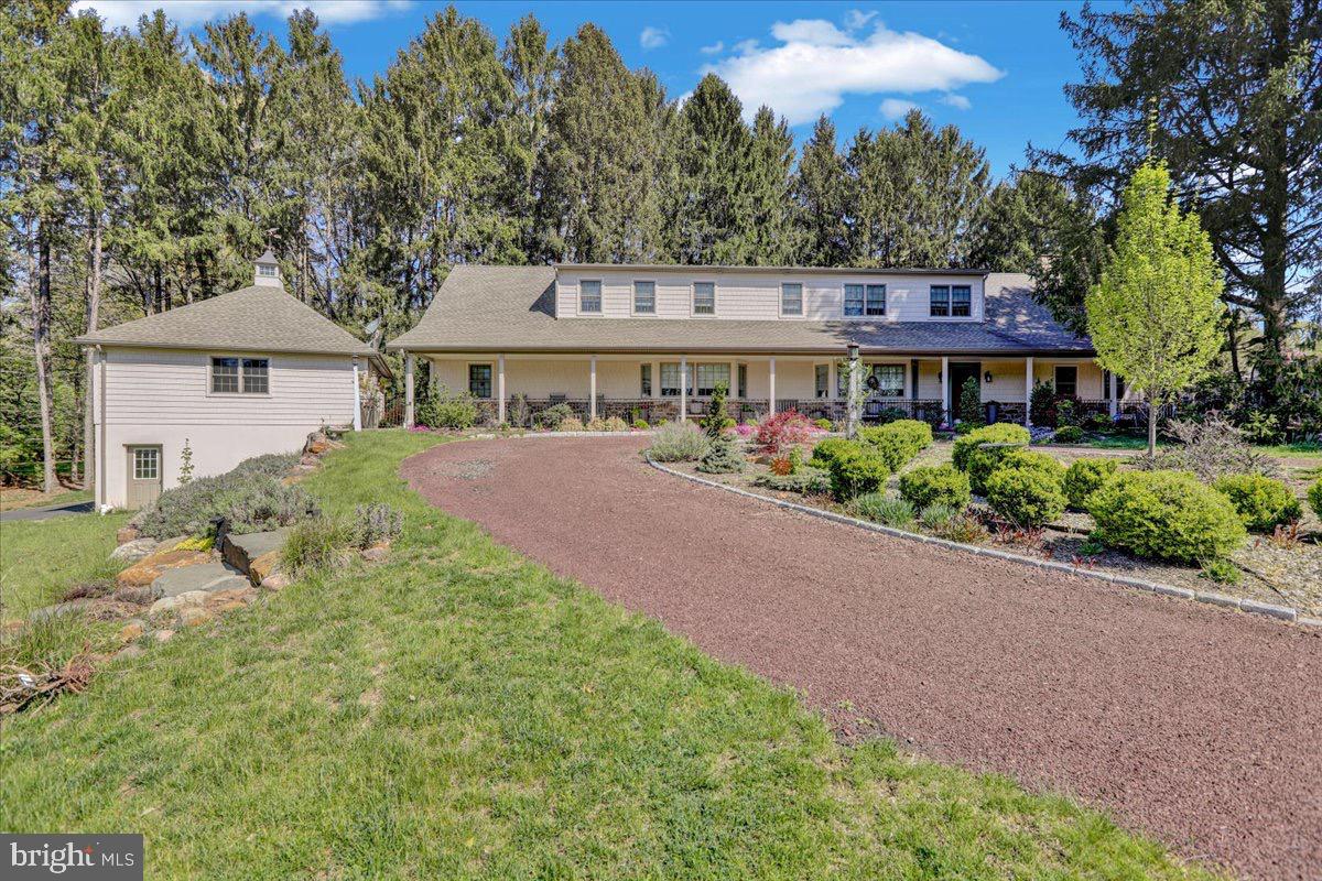 338 Candy Road Mohnton, PA 19540 - Photo 5 of 63 a front view of a house with a garden and trees
