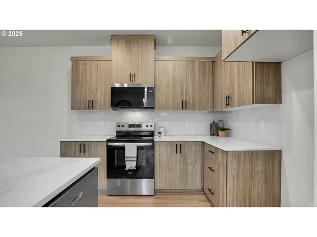 a kitchen with a sink dishwasher and a dining table with wooden floor