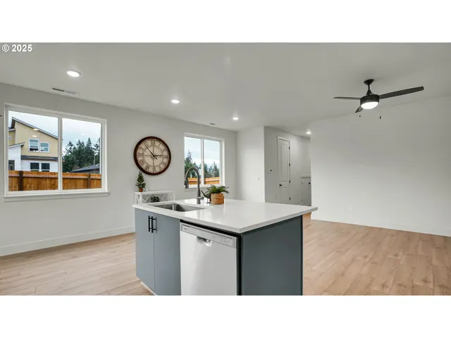 a kitchen with a sink cabinets and wooden floor