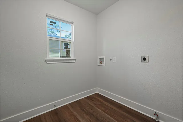 a view of a hallway with wooden floor and stairs