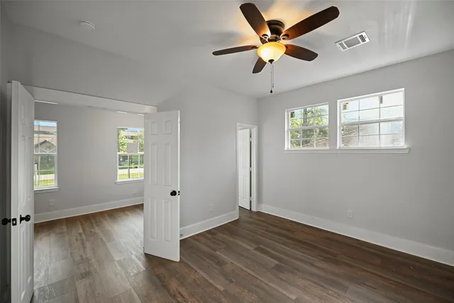 a view of an empty room and wooden floor