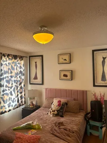 a bedroom with a bed and couch