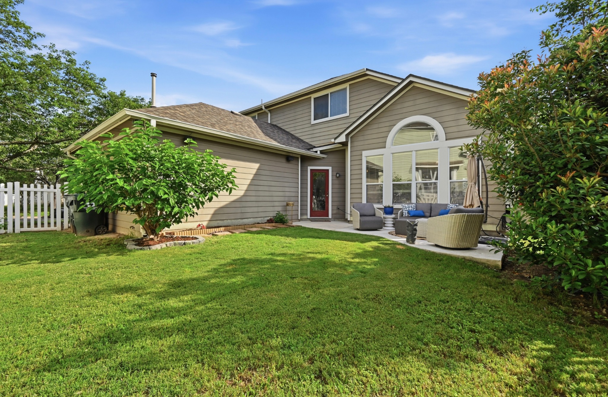 5888 Fergus Kyle, TX 78640 - Photo 31 of 40 A verdant lawn extends from a private patio with outdoor seating, perfect for al fresco enjoyment.