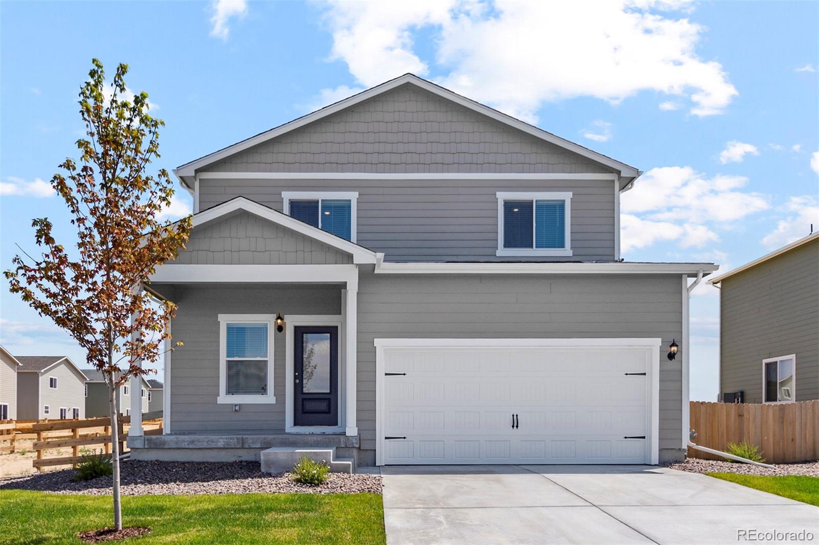 7402 Crystal Avenue Frederick, CO 80530 - Photo 1 of 26 a front view of a house with garden
