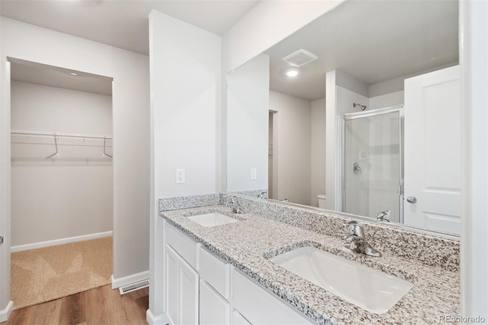 7402 Crystal Avenue Frederick, CO 80530 - Photo 10 of 26 a bathroom with a granite countertop sink and a mirror