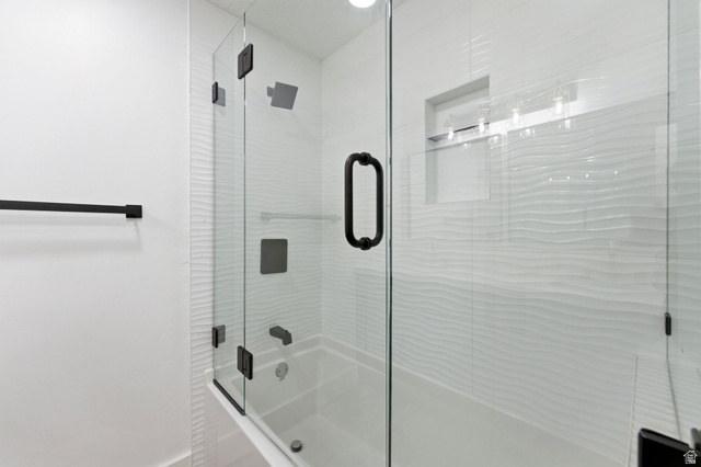 871 Bonita Way Centerville, UT 84014 - Photo 19 of 61 Bathtub and shower combination featuring a glass enclosure with matte black hardware