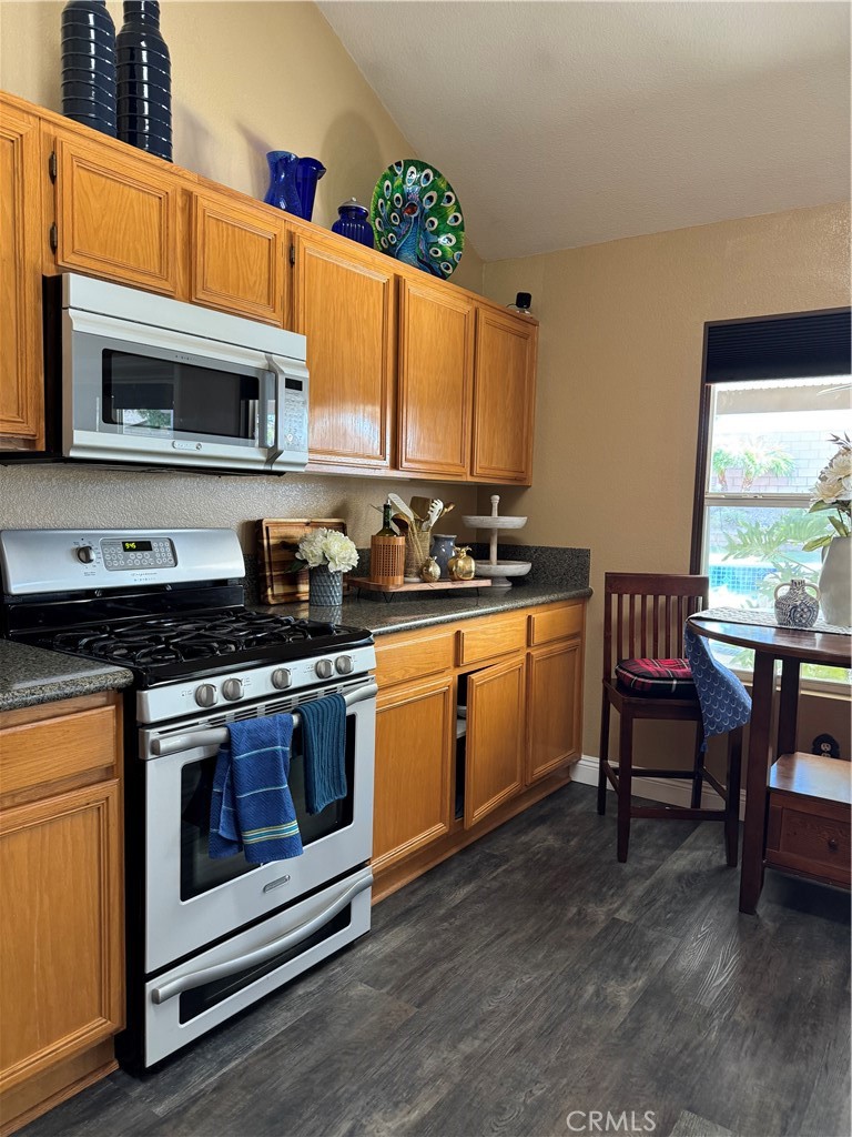 1806 Madison Street Redlands, CA 92374 - Photo 29 of 31 a kitchen with stainless steel appliances granite countertop a stove a sink and a microwave