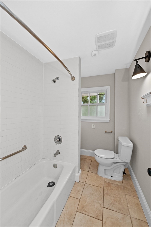 18 Bennett Street, Unit 2 Manchester, MA 01944 - Photo 5 of 21 a bathroom with a toilet a sink a mirror and a bathtub