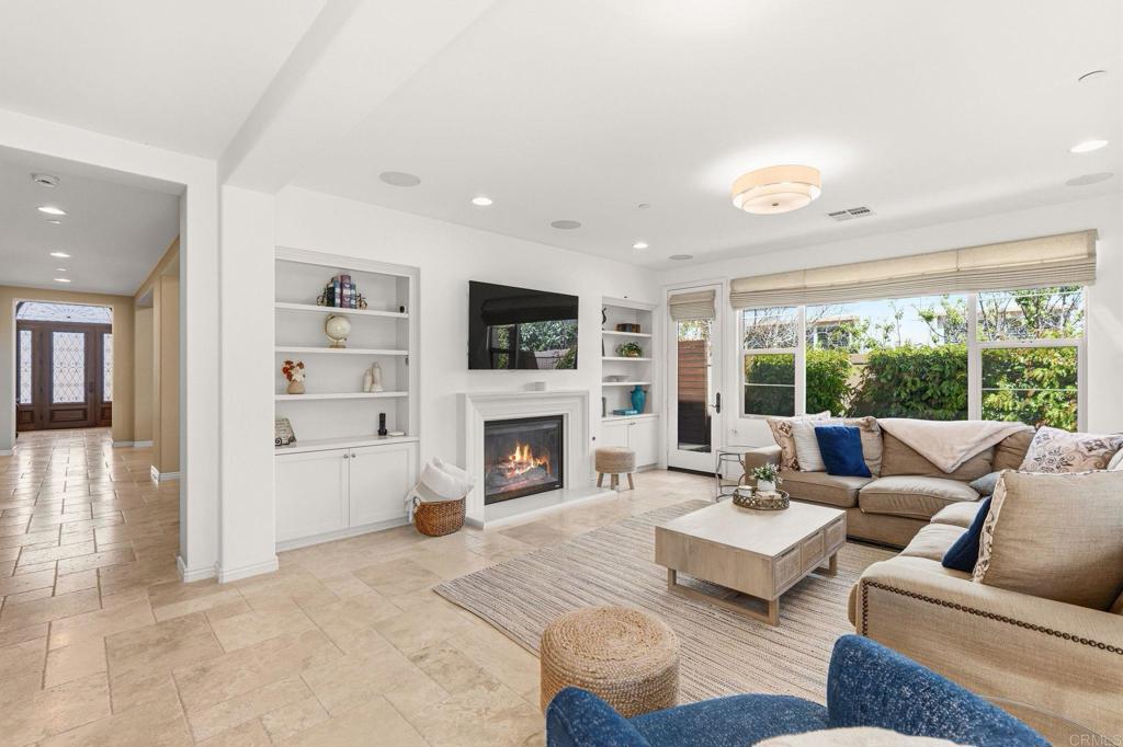 809 Dolphin Circle Encinitas, CA 92024 - Photo 22 of 71 a living room with furniture a fireplace and a flat screen tv