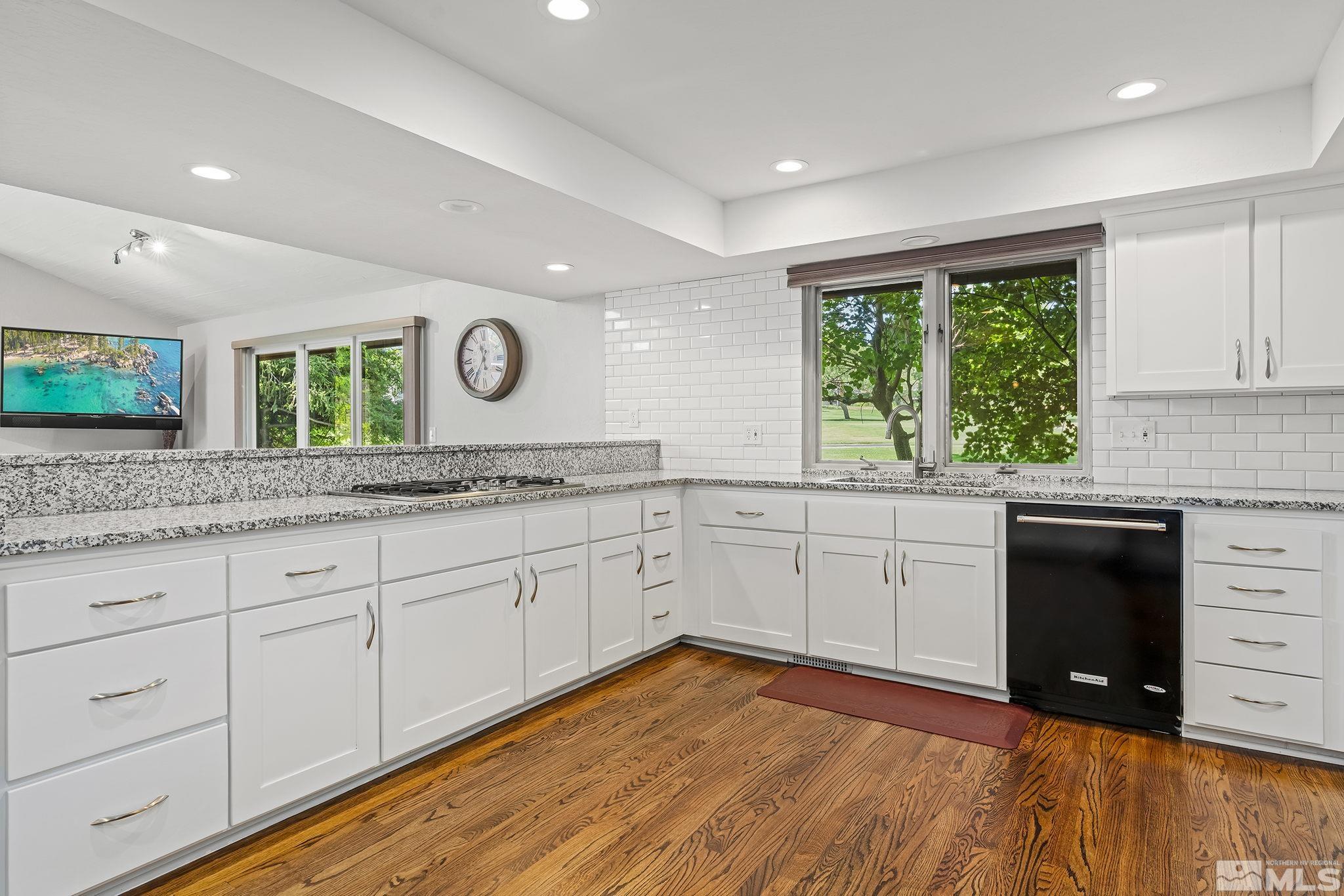 1953 South Villa Way Reno, NV 89509 - Photo 11 of 31 a kitchen with granite countertop white cabinets and a large window