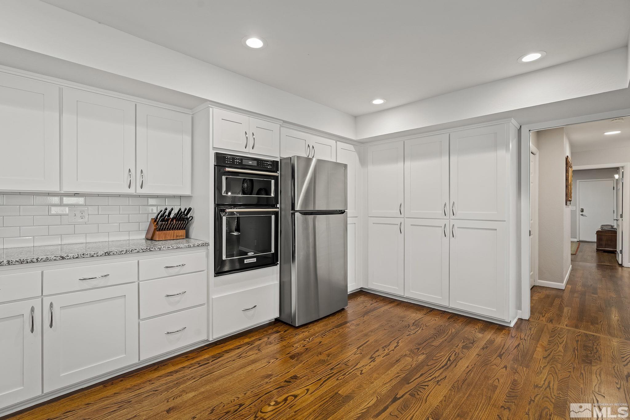 1953 South Villa Way Reno, NV 89509 - Photo 12 of 31 a kitchen with stainless steel appliances a refrigerator and wooden cabinets