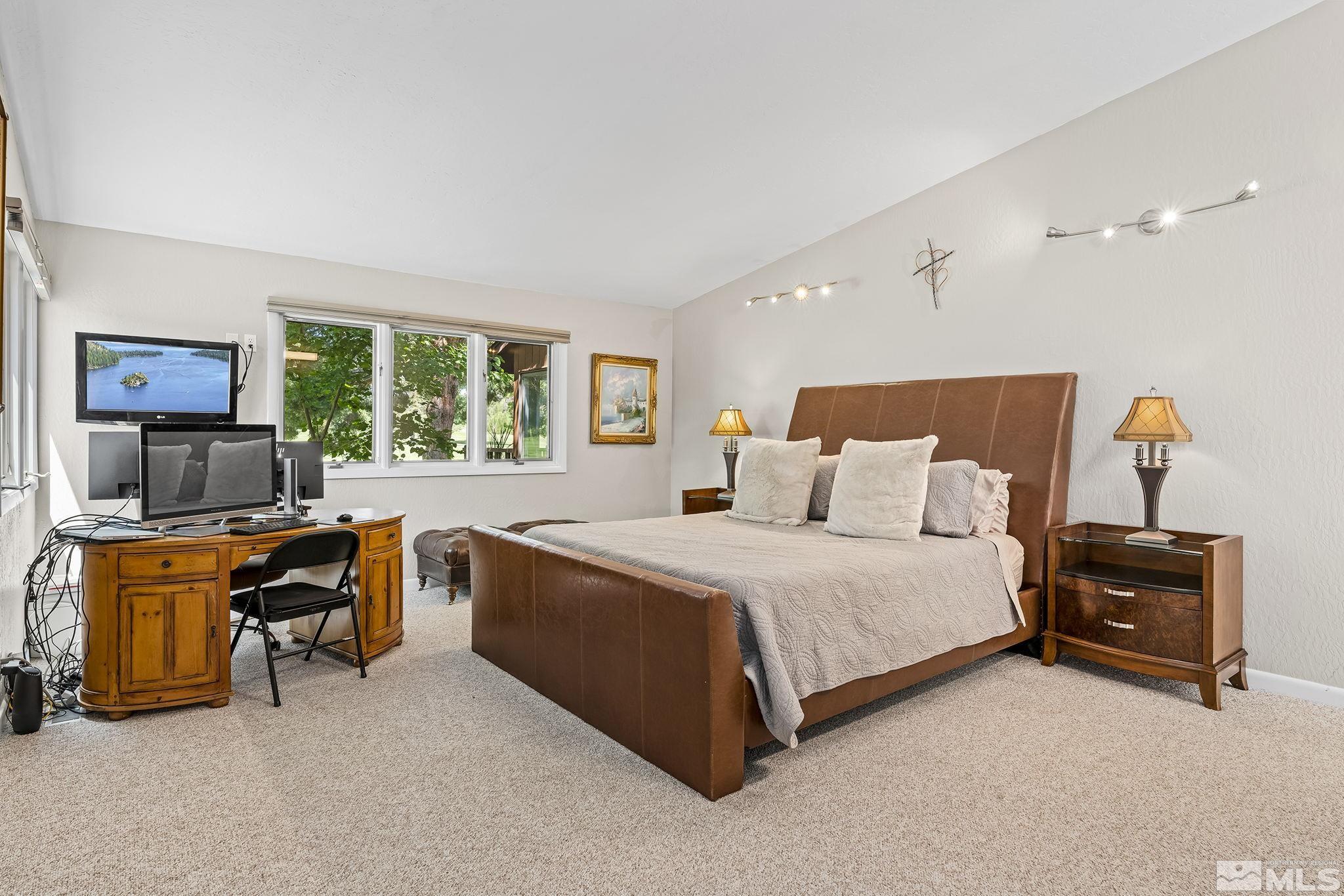 1953 South Villa Way Reno, NV 89509 - Photo 17 of 31 a bedroom with a bed and a desk