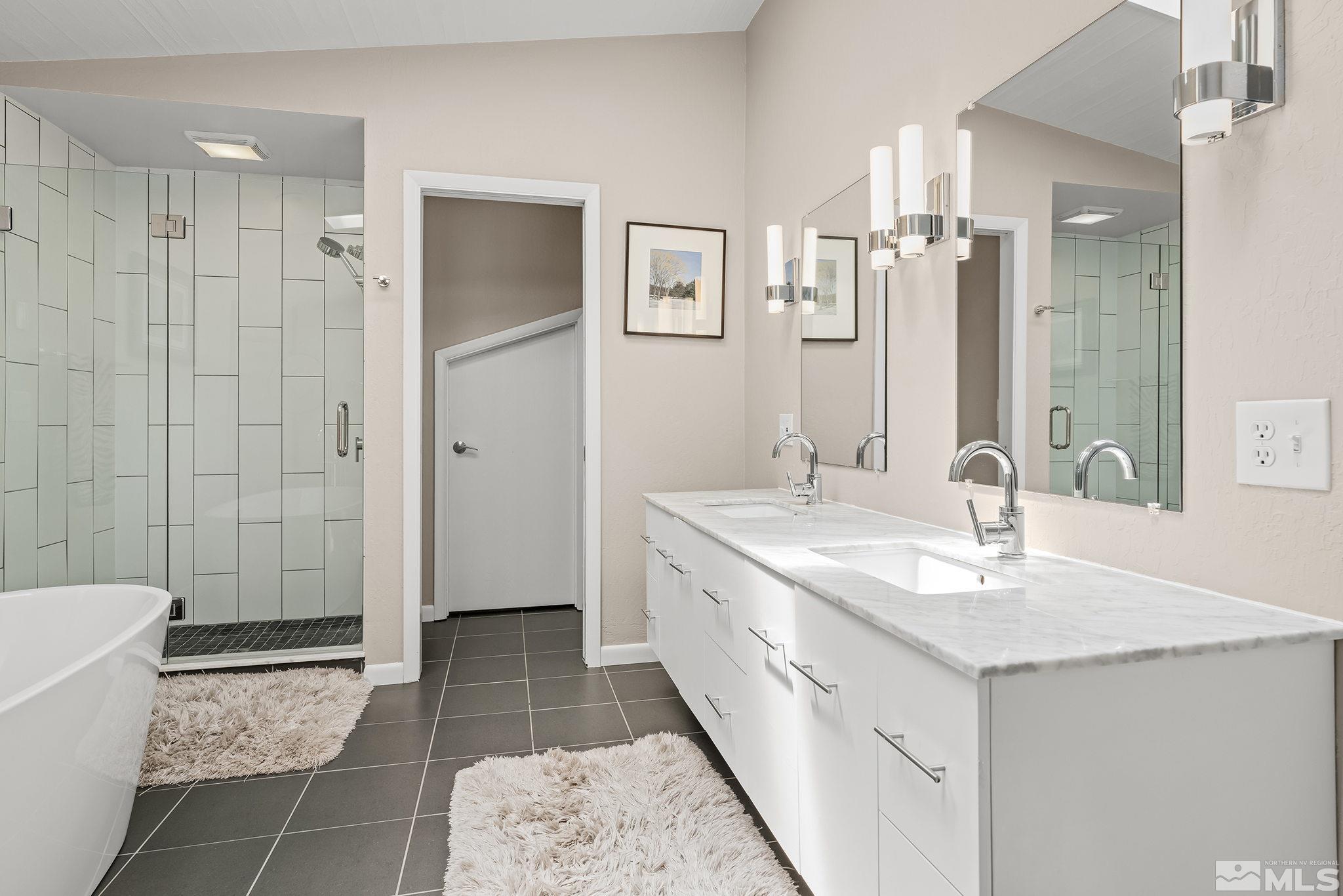 1953 South Villa Way Reno, NV 89509 - Photo 18 of 31 a bathroom with a double vanity sink a toilet and a mirror