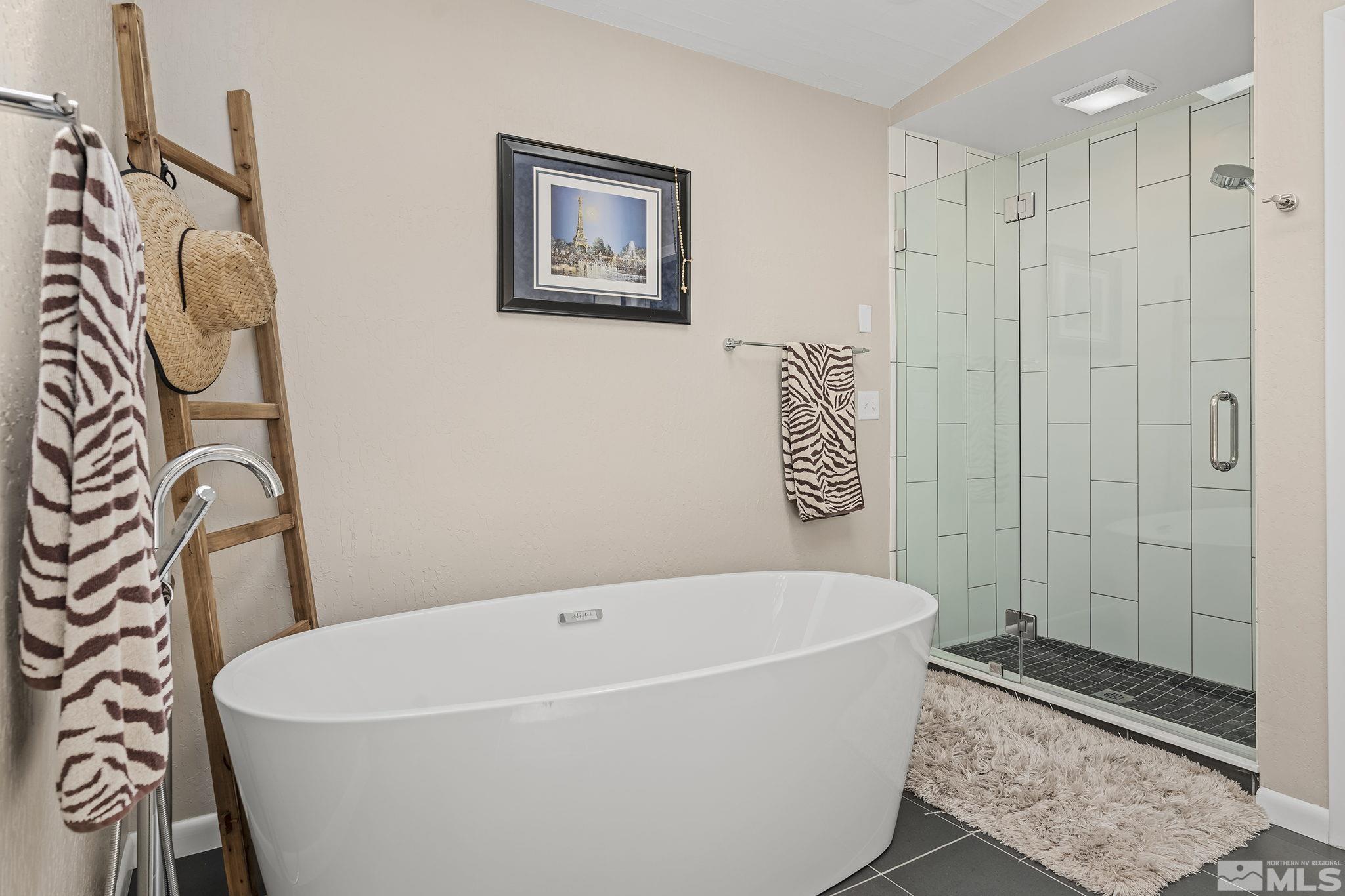 1953 South Villa Way Reno, NV 89509 - Photo 19 of 31 a bathroom with a bathtub and shower