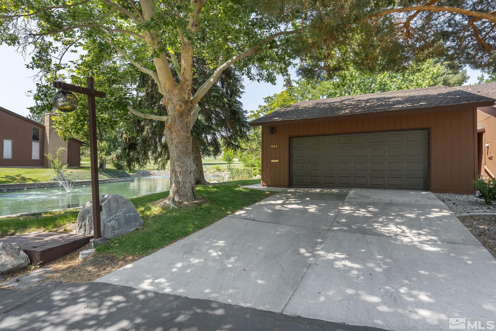 1953 South Villa Way Reno, NV 89509 - Photo 2 of 31 a front view of a house with a yard and garage