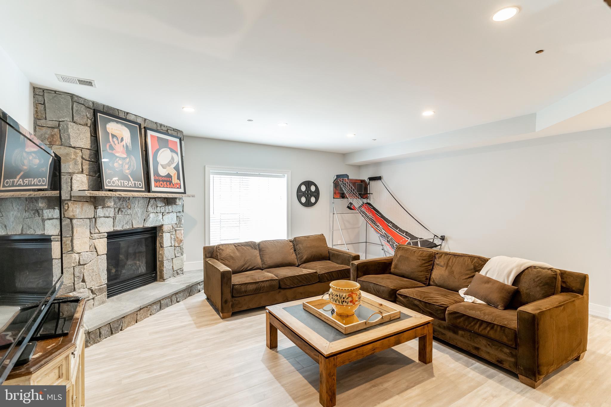 8582 Brickyard Road Potomac, MD 20854 - Photo 27 of 35 Lower Level Recreation Room with Fireplace