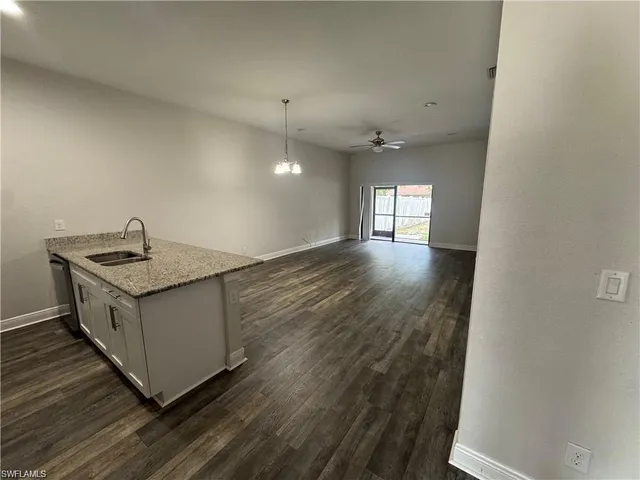 a kitchen with granite countertop a sink and a stove