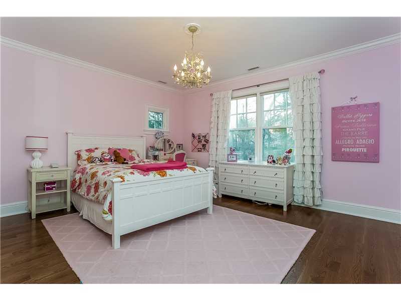 101 Raymond Street Darien, CT 06820 - Photo 16 of 25 a bedroom with a bed and a chandelier