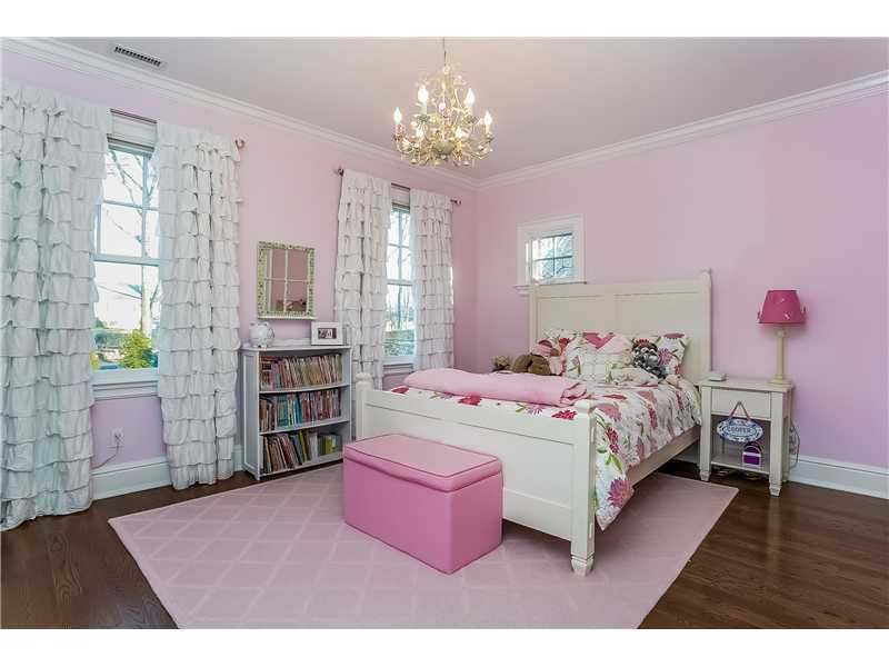 101 Raymond Street Darien, CT 06820 - Photo 18 of 25 a bedroom with a bed dresser and a chandelier