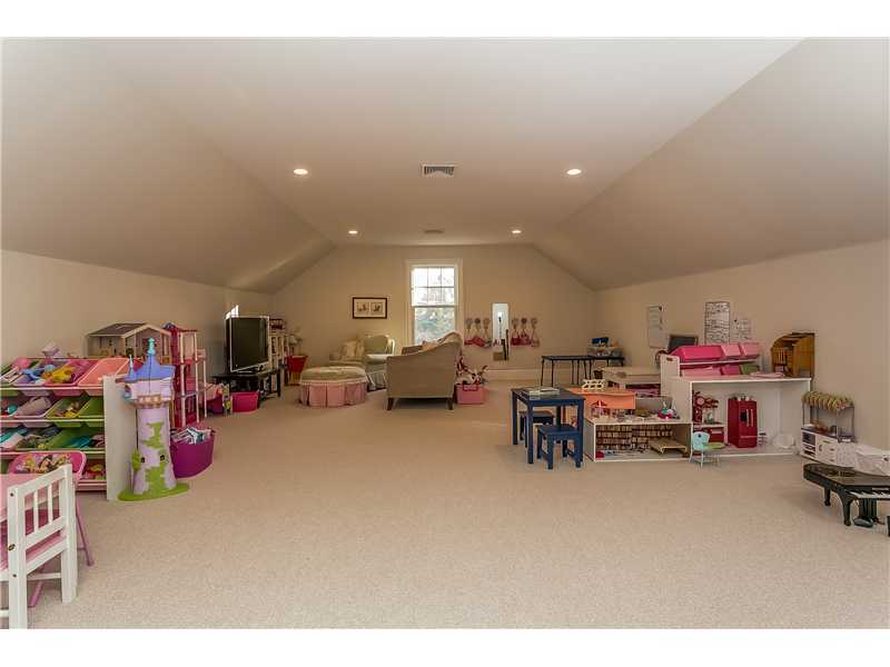101 Raymond Street Darien, CT 06820 - Photo 21 of 25 a living room with lots of furniture and a flat screen tv