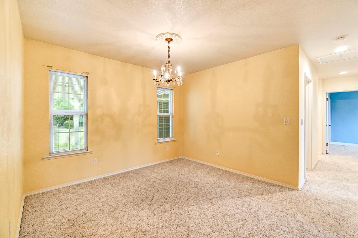 2020 Short Drive Hanford, CA 93230 - Photo 15 of 38 an empty room with windows and chandelier