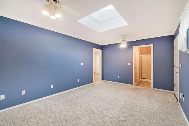 a view of an empty room with a ceiling fan