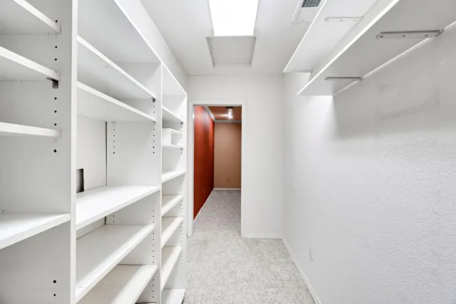 a view of hallway with stairs and wooden floor
