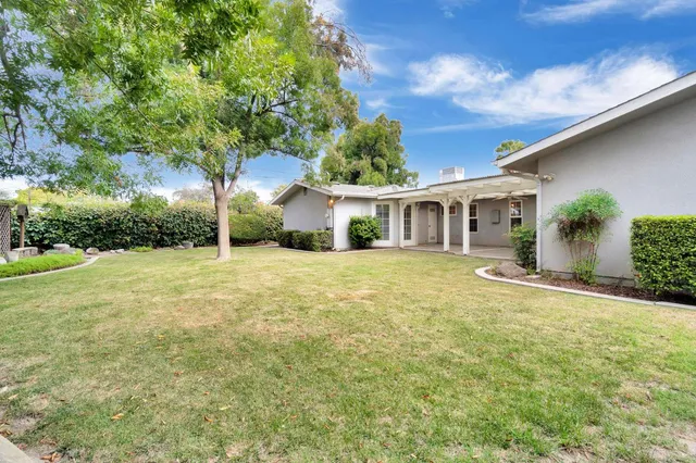 a front view of house with yard and green space