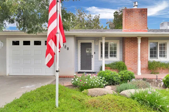 a view of a house with backyard and sitting area