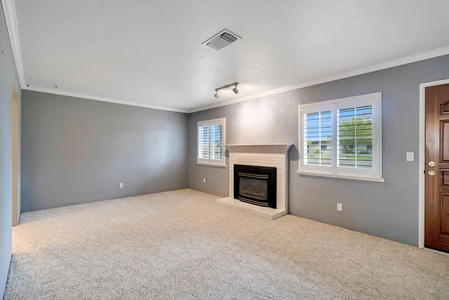 a view of empty room with a fireplace
