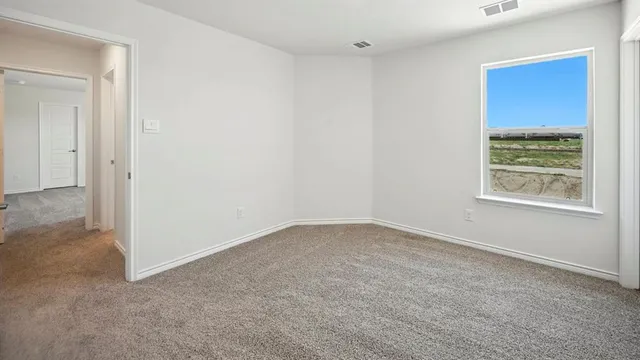 a view of an empty room with a window