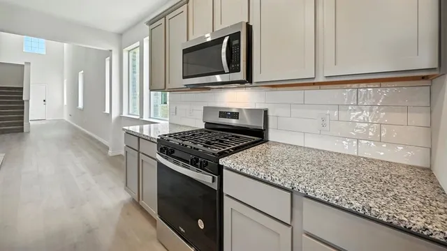 a kitchen with granite countertop a sink and a window