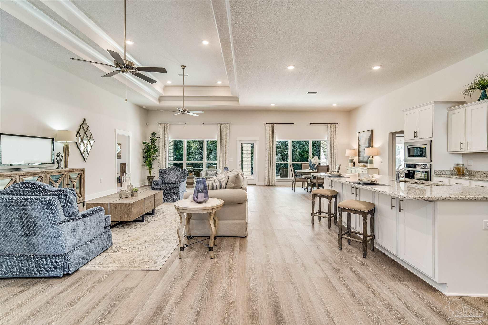 5780 Windham Road Milton, FL 32570 - Photo 11 of 37 a living room with lots of furniture and kitchen view